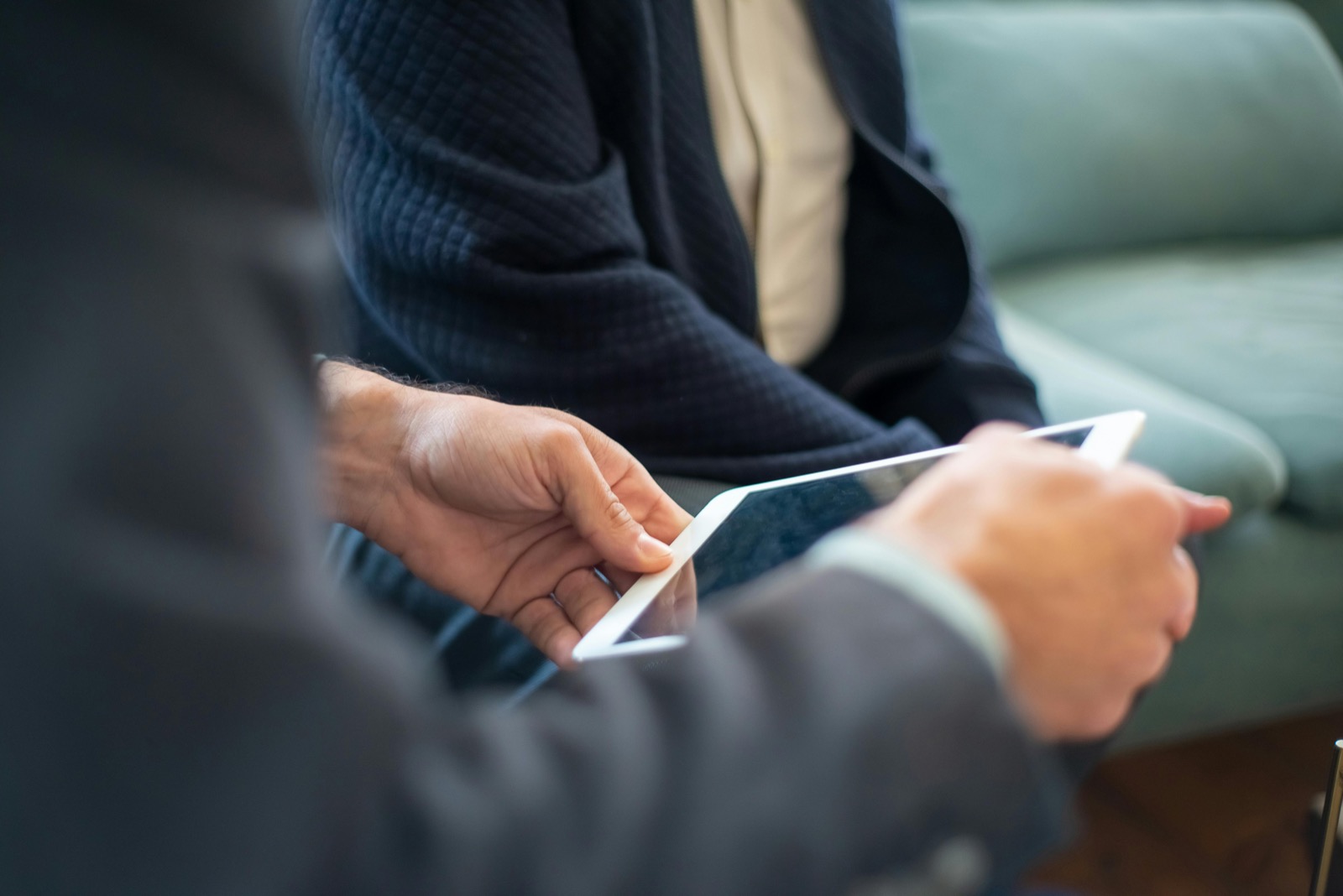 Business consultant using a tablet while discussing reseller services